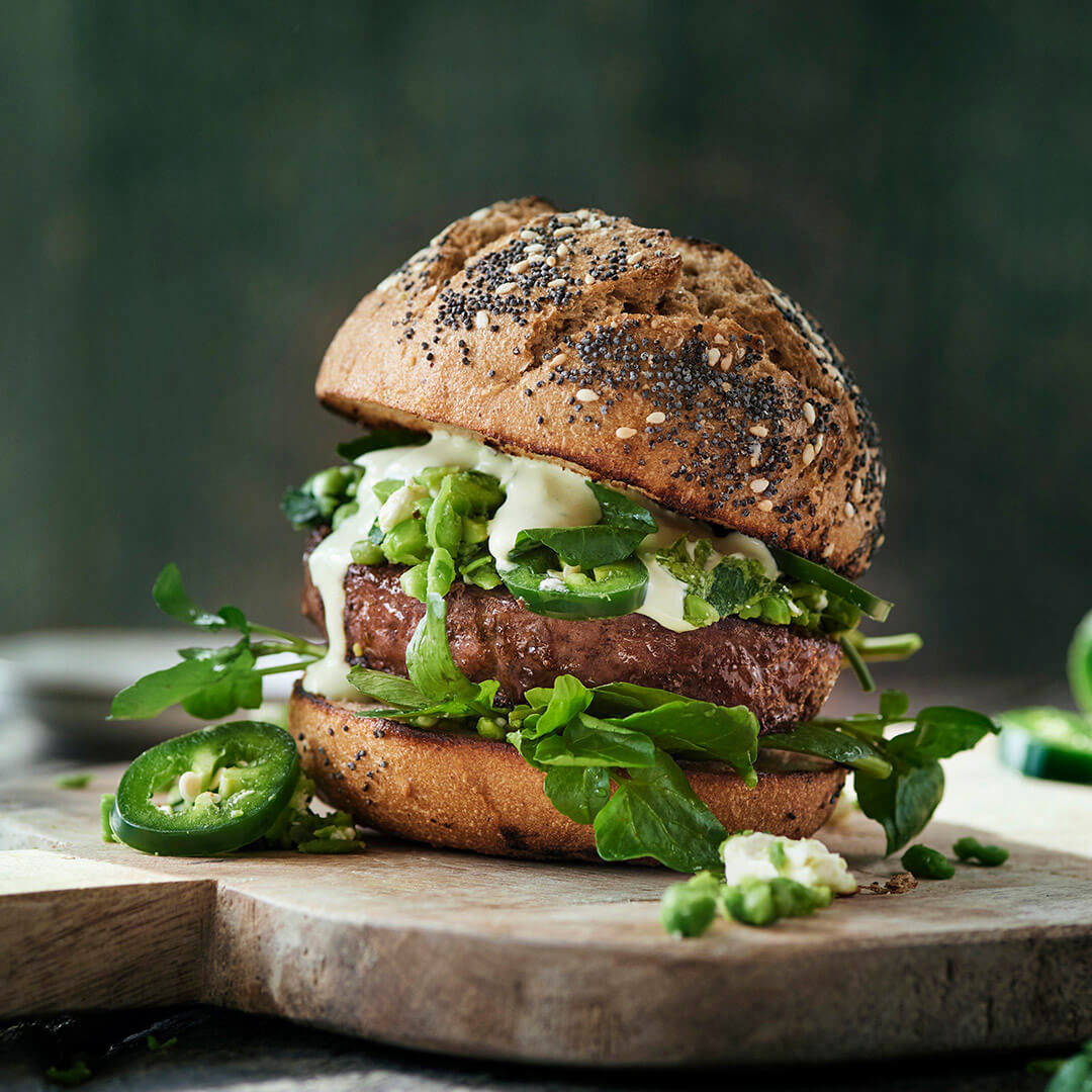 The Frozen Butcher Angus Burger with green pea spread and jalapeño pepper sauce